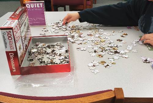 person putting puzzle together
